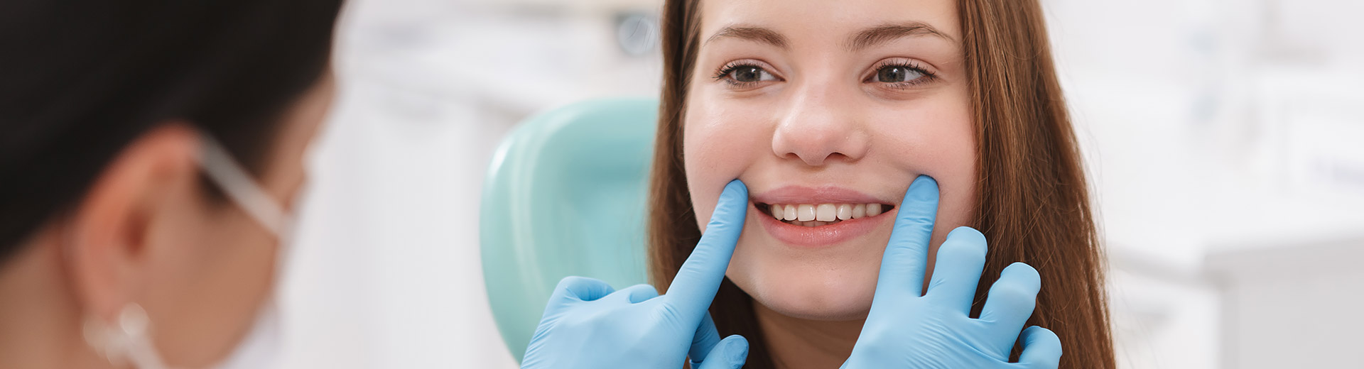 A patient receiving a dental cleaning and exam.